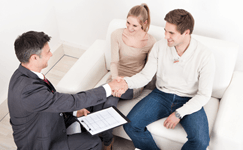 Homeowners discussing documents with an advisor